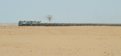 The iron ore trains are 2km long and make the daily journey to the coast through the desert haze.